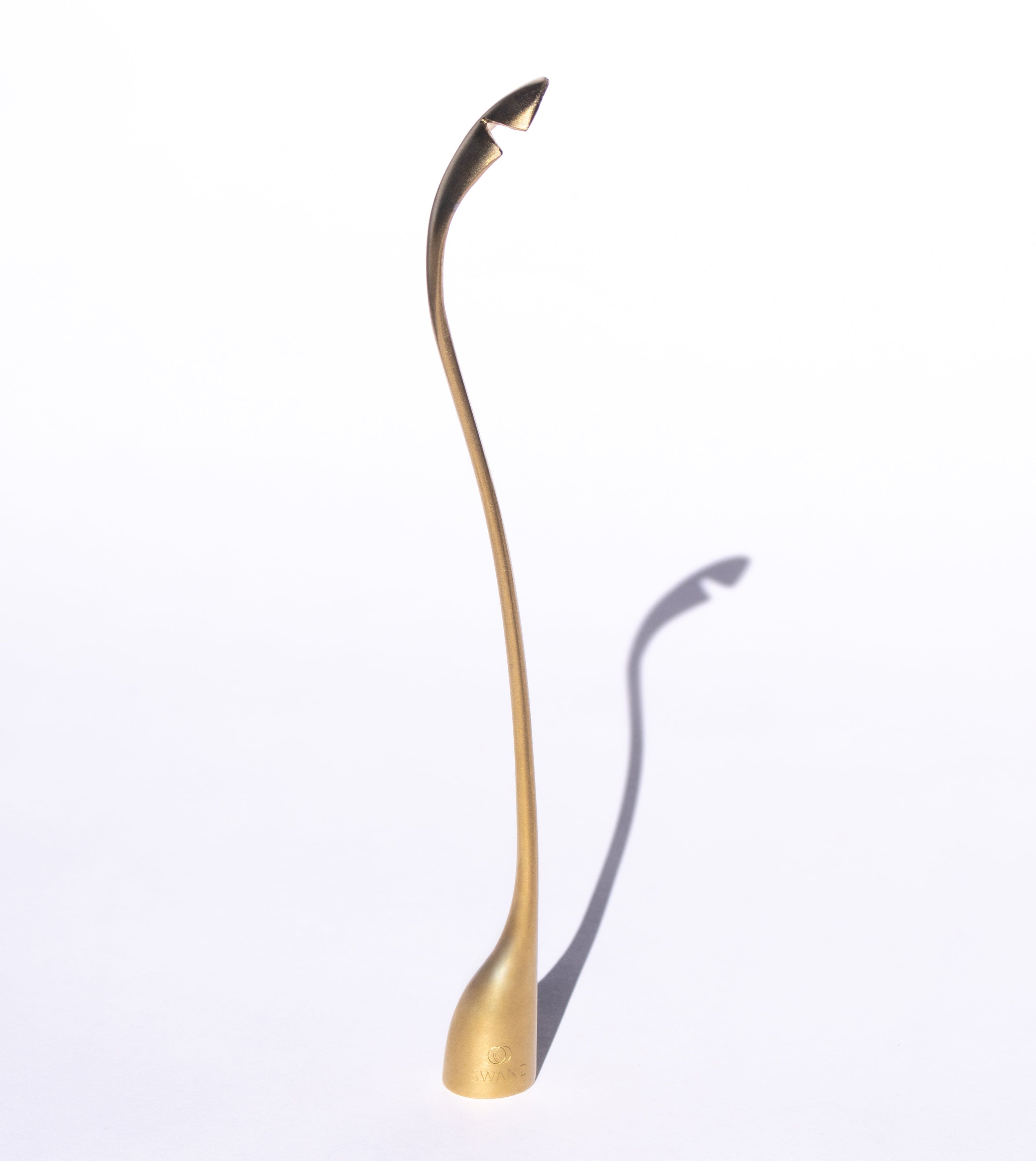 SWAND 4-in-1 sustainable candle care tool in brushed metal finish, featuring trimmer, snuffer, dipper, and rescue spoon.